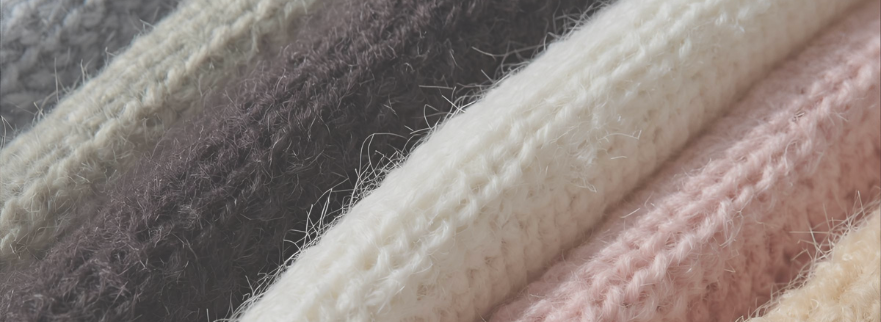 Close-up shot of a bundled stack of clothes in a variety of colors